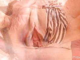 Playful brunette is having fun and masturbating on the bed