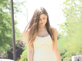Brunette teen is having fun outdoors in sexy short dress